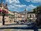 Dynamic street view of Madero Street in Morelia, featuring historic colonial architecture and daily urban life against a mountain