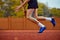 Dynamic strides hinting at upcoming leap. Cropped photo of male sportsman fast running on sport court to make new record