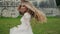 Dynamic video of a beautiful blonde in white dress