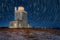 Dyrholaey lighthouse under star trails.