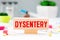 Dysentery, word cube with background, medical concept