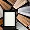 The e-book with a clean white screen rests on the open multi-colored books. ready to read