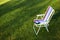 E-Book reader on the chair, green grass background