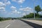 E-Highway with electric overhead contact wire for hybrid trucks, test track in Luebeck, Germany, blue sky with clouds, copy space