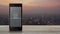 E learning flat icon on modern smart mobile phone screen on wooden table over blur of cityscape on warm light sundown, Business st