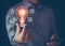 E-learning graduate certificate program concept. Man holding lightbulb and graduation hat icon