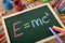 E=mc2 formula written in chalk on small blackboard