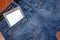 An e-reader hidden in a pocket of jeans pants