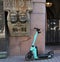 An e-scooter parked by a historic building