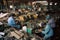 e-waste recycling center, with workers sorting and dismantling devices