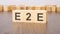 e2e text on wooden blocks. wooden background. foreground