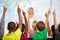 Eager young minds ready to answer all their teachers questions. school kids raising their hands to answer a question