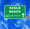 EAGLE BEACH road sign against clear blue sky