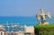 Eagle guards the gate to Bahai Gardens and overlooks the cityscape and coast of Haifa