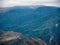 An eagle hovers over a mountain peak using ascending air current