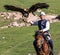 Eagle Hunter holds his eagles on horseback, ready to take flight