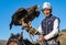 Eagle Hunter holds his eagles on horseback, ready to take flight