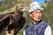 Eagle Hunter holds his eagles on horseback, ready to take flight