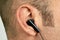 Ear with earphone closeup