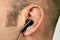 Ear with earphone closeup