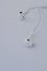 In-ear headphones are wired. White wired headphones lie on a white background. The concept of modern technologies and