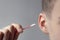 Ear of a young man close-up, cleaning the ear with a cotton swab, ear diseases, daily hygiene