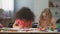 Early education, two multi-ethnic female kids drawing with colorful pencils