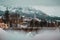 Early evening panorama of Cortina d'Ampezzo tower. Bridge over river in foreground