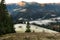 Early frosty morning in the mountains. A wooden shed in the pasture, fields covered with hoarfrost and mountains overgrown