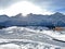 An early frosty morning and the rising sun over the snowy alpine peaks of the famous Swiss winter resort of Arosa