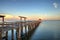 Early moonset and sunrise over the Naples Pier on the Gulf Coast of Naples, Florida