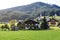 Early morning in Austria. Traditional Austrian landscape: mountains, cozy houses and green lawns. Euro trip. Feeling of calm and