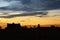 Early morning cloudscape with silhouette of building