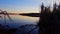 Early morning dawn view of calm lake in summer. Tranquil lakeside landscape