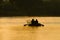 Early morning. Fishermen on a boat. Silhouette of two fishermen