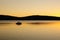 Early morning fishing boat on a lake at dawn