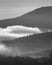 Early morning fog and mist between rolling hills in the Scottish Highlands