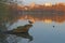 Early morning lights of dawn on the lake with city in background