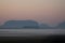 Early morning mist over a farmers field with windmills and crops barely visible