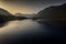 Early morning paddle boarders sail across Crummock Water a lake in the Lake District part of the UNESCO World Heritgae Centre in