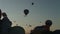 Early morning and silhouettes of balloons going into the sky