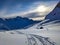 early morning ski tour in the grison mountains above davos. Sunrise through clouds with a special weather mood