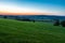 early morning with a sky full of beautiful colors during sunrise in the rolling hills landscape of Limburg