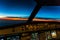 Early morning sunrise - captains view in the flight deck of a modern airliner airplane