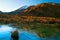 Early morning sunrise, landscape scenery of frozen blue pure water lake, wild mountains and huge volcano with snow on the peak