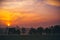 Early morning sunrise over a park with city view on horizon