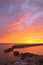 Early morning before sunrise by the sea. A mysterious colorful sky and reflection at sea. Old harbor pier. Estonia. Portrait image