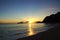 Early Morning Sunrise on Waimanalo Beach over Rock Island bursting through the clouds