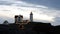 Early morning sunrise with waves crashing on rocks and twinkling lights at Christmas, Nubble Lighthouse, York, Maine, 2018