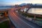 Early morning view of car trails on a curved highway bridge over beautiful Tamsui River in Taipei City,Taiwan